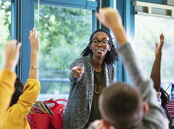 Teacher calling on a student who has their hand raised