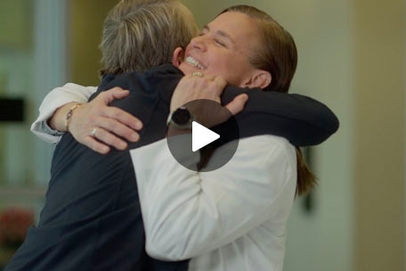A member hugging a doctor