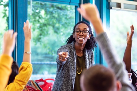 Teacher calling on a student who has their hand raised