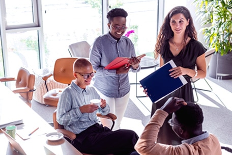 Office workers talking in an employee lounge