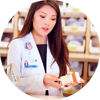 Pharmacist preparing a prescription bottle.