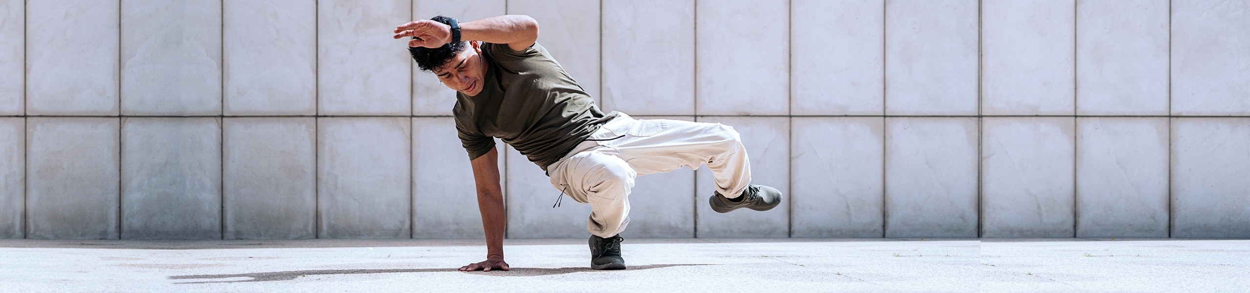 Breakdancer doing a down rock move