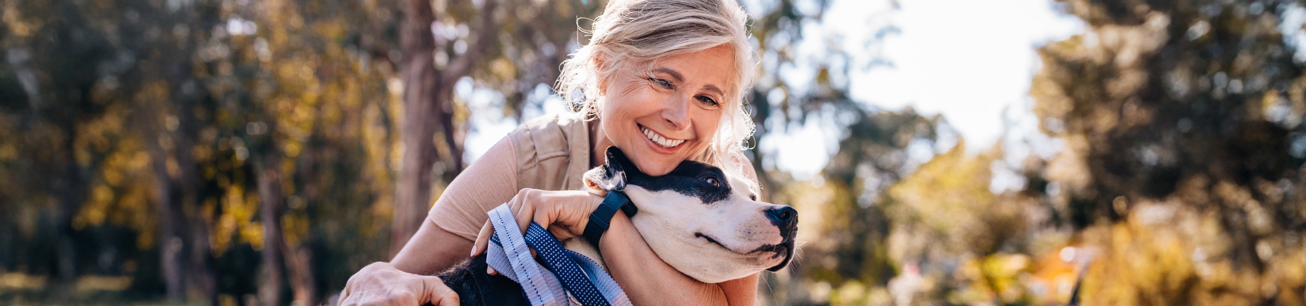 Person smiling while hugging a dog