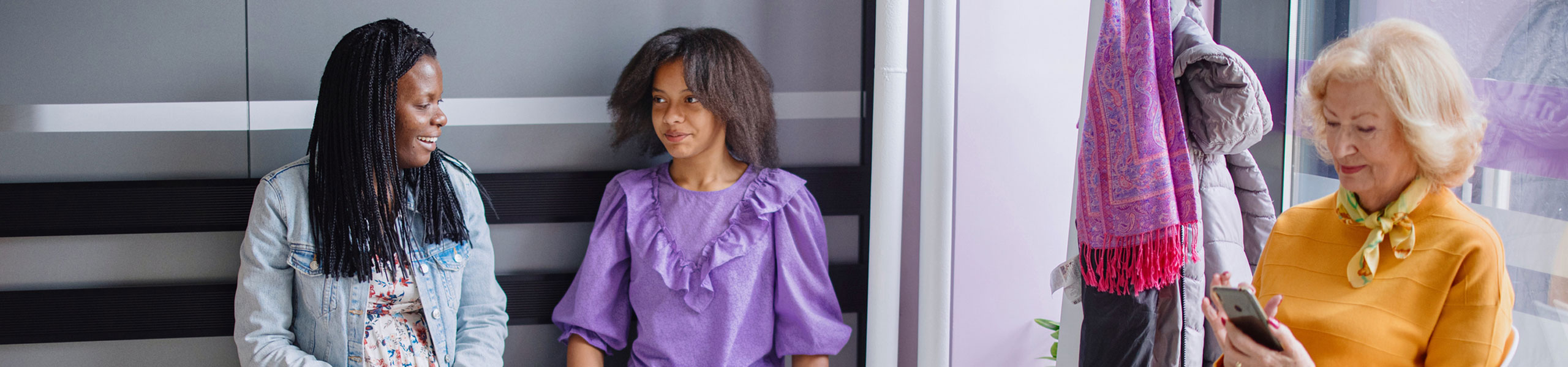 teenage girl sitting with her mom in waiting room