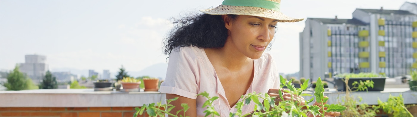A woman gardening on a rooftop