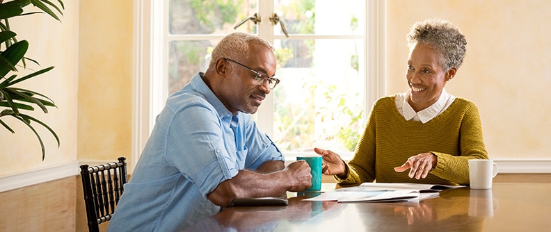 Two people discuss diabetes while sitting at a table