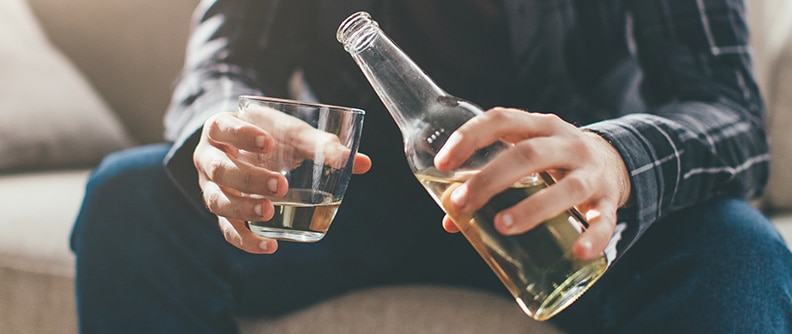 A man pours beer into a glass