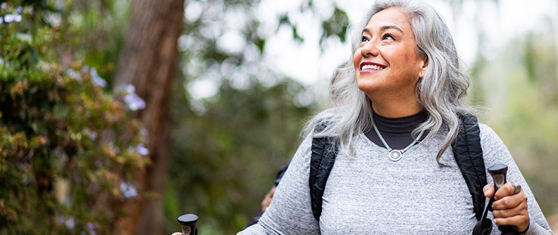 Smiling woman looks up while hiking