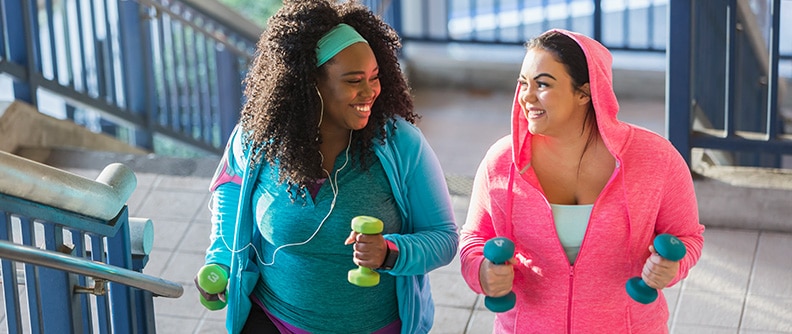 Two women exercising outside