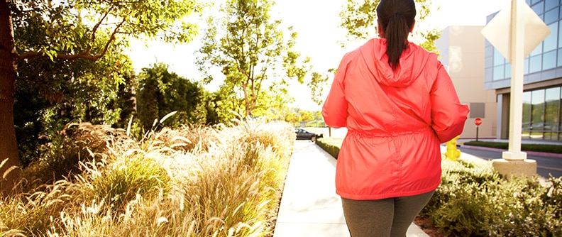 A woman walking briskly down a path