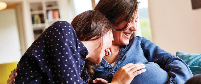 Pregnant couple holding belly