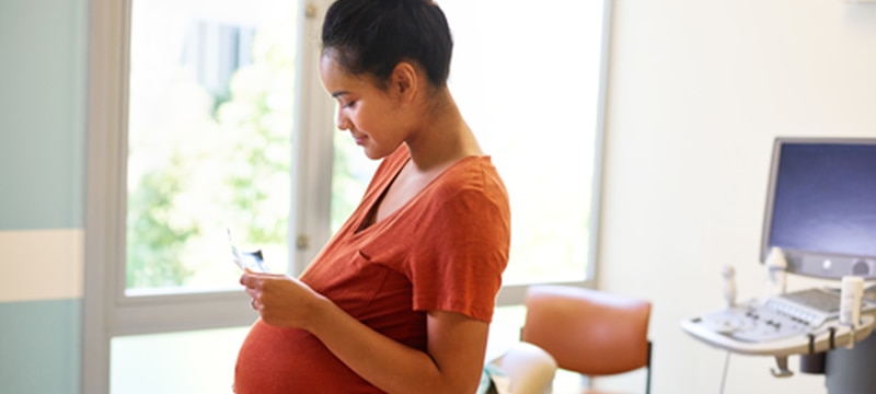 Pregnant woman reading a test result