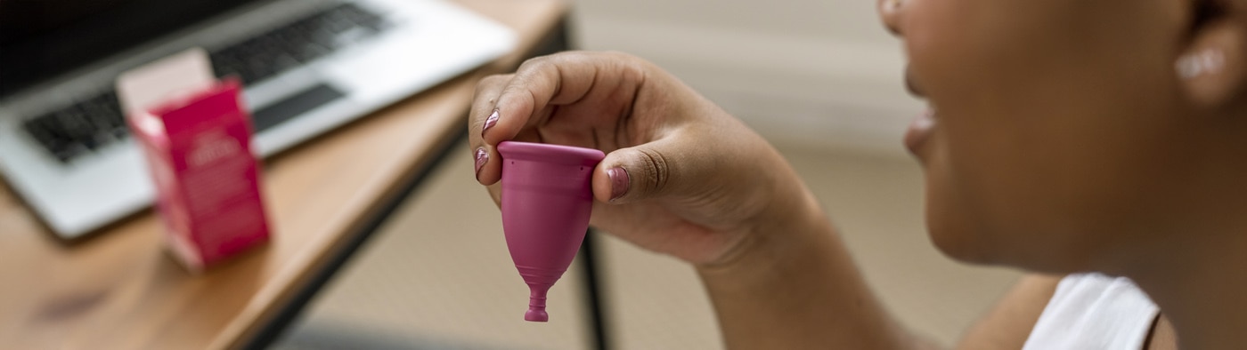 Person holding a menstrual cup
