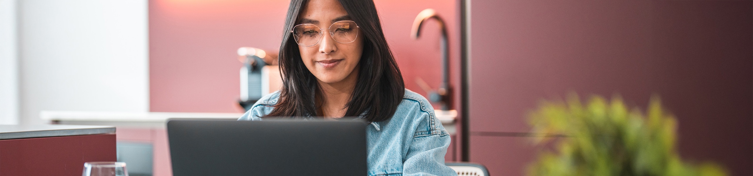 Young adult sitting and working on their laptop