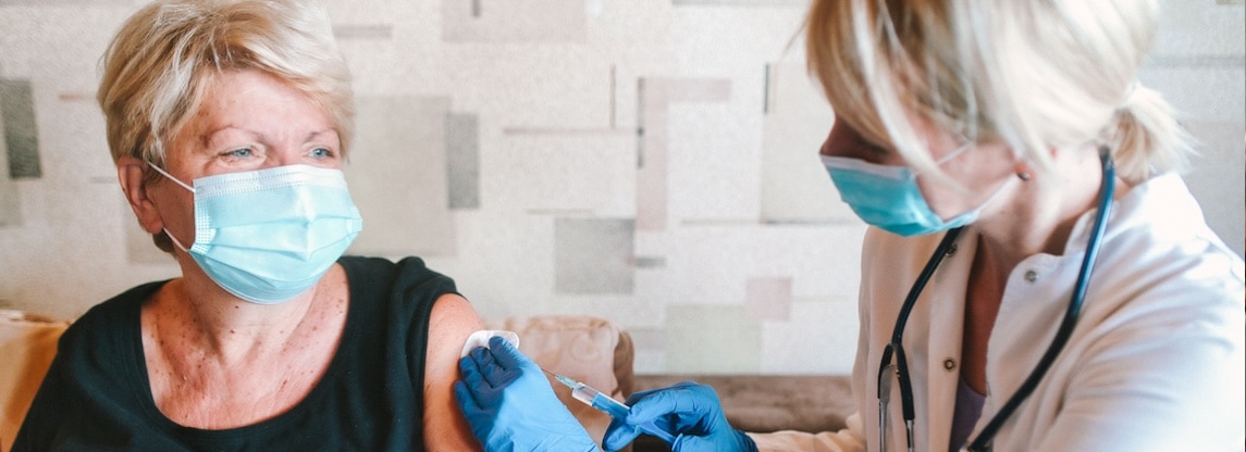 physician giving patient COVID shot