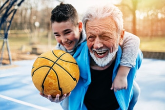 Grand parent playing basketball with grand child