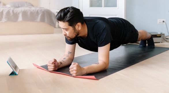 Man exercising with tablet