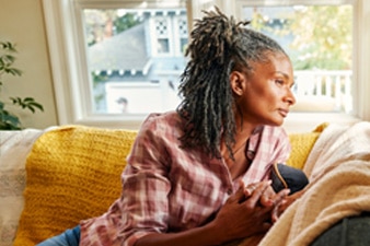 Person sitting on couch and looking out window