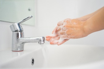 Person washing hands with soap