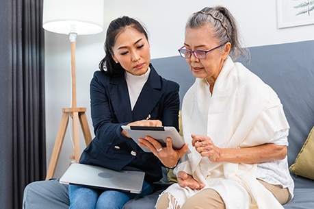 Two people reading a computer tablet