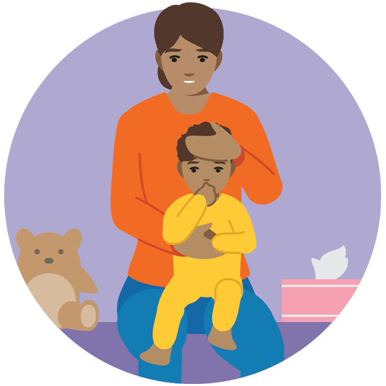 Parent checking their baby’s forehead temperature