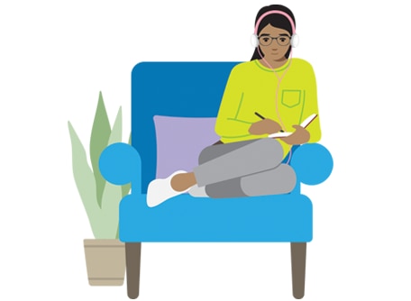 young person sitting in a chair and journaling