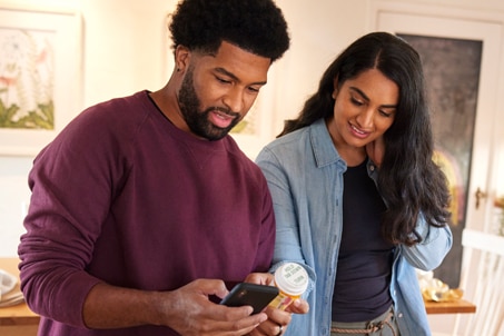 Couple refilling prescription on their phone text media
