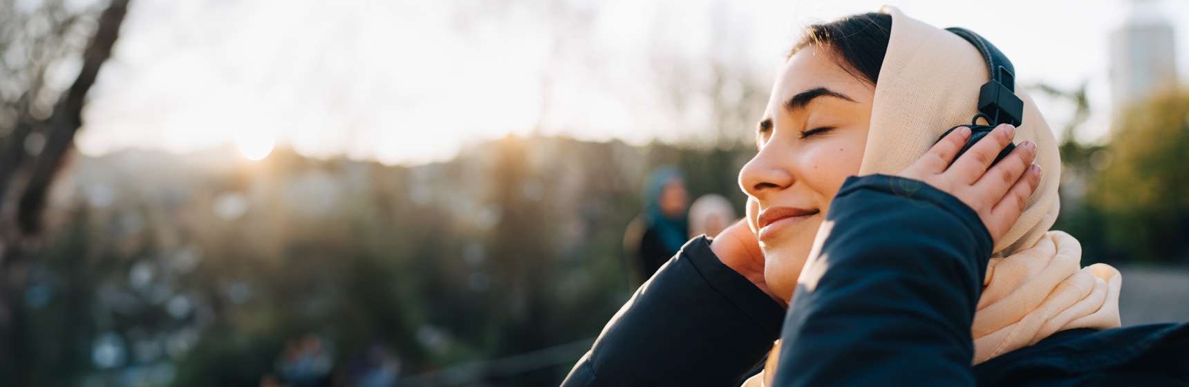 Person enjoying music on headphones with eyes shut