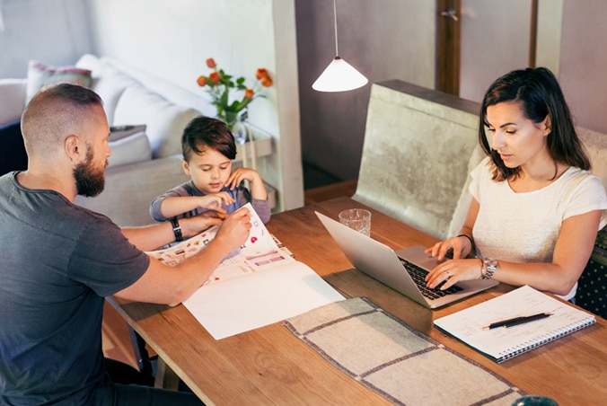 A family reviewing paperwork together at home