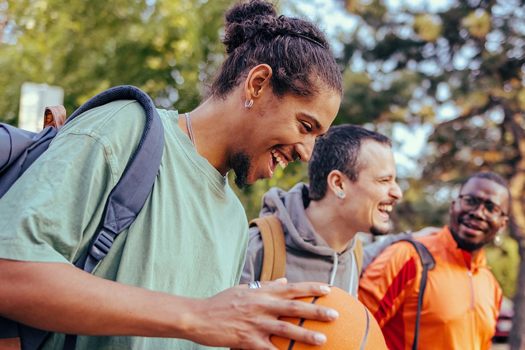 Friends walking with basketball