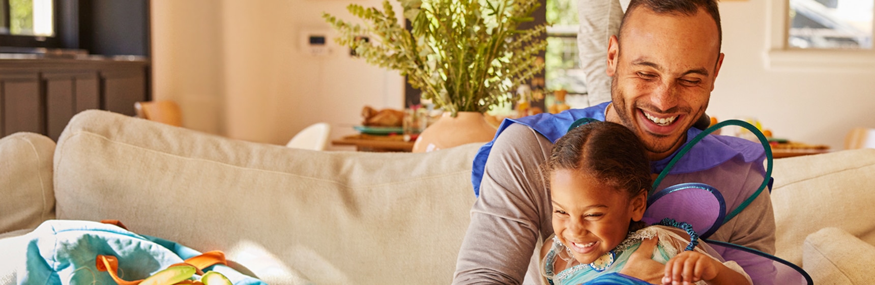 Adult and child playing on couch