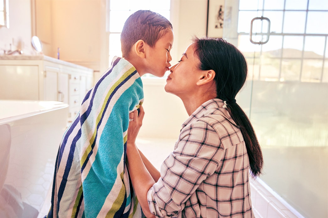 Child kissing parent after a bath