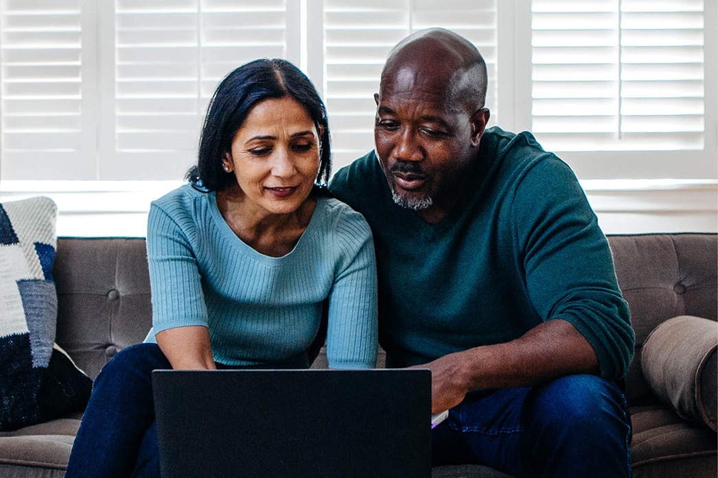 Two people reading health plan information online
