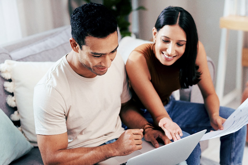 Couple using laptop for paperwork