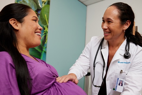 Doctor examining a pregnant person