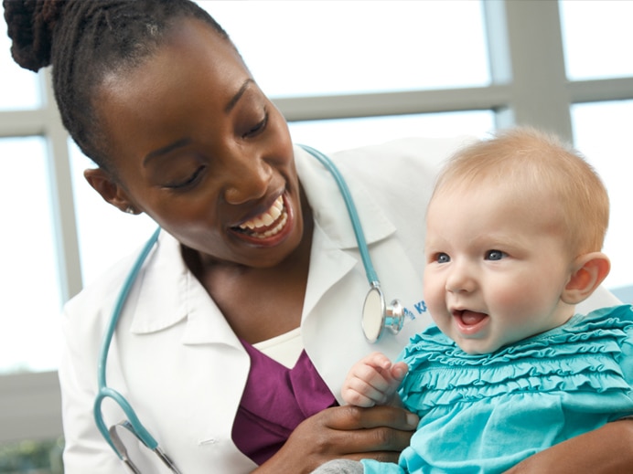 Doctor holding infant patient