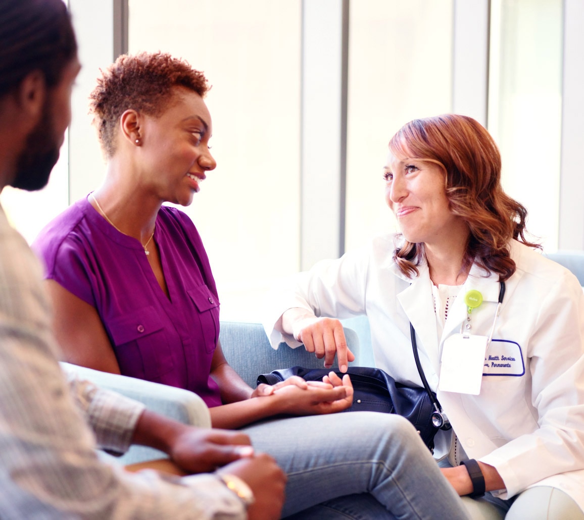 A smiling member visiting their doctor