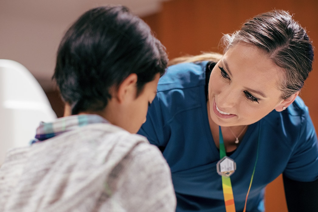 Nurse talking to young child