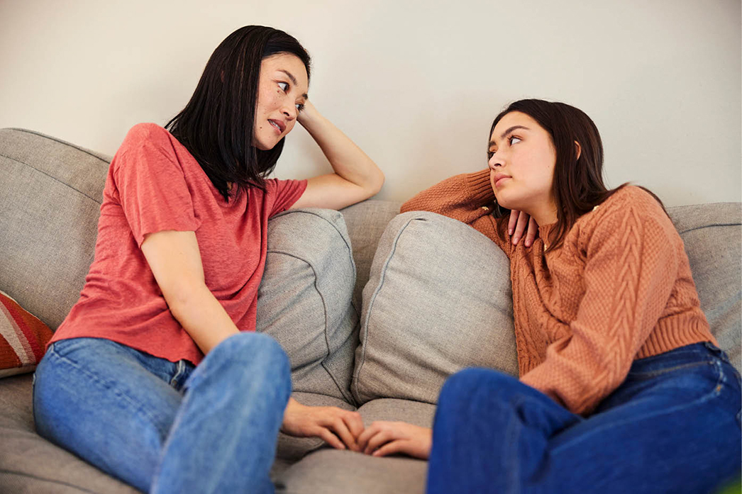 Parent and teen talking on a couch