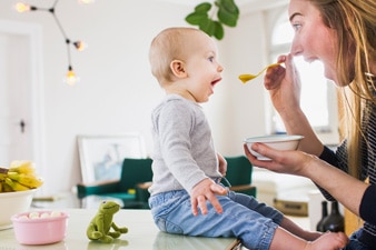 Parent feeding baby at home