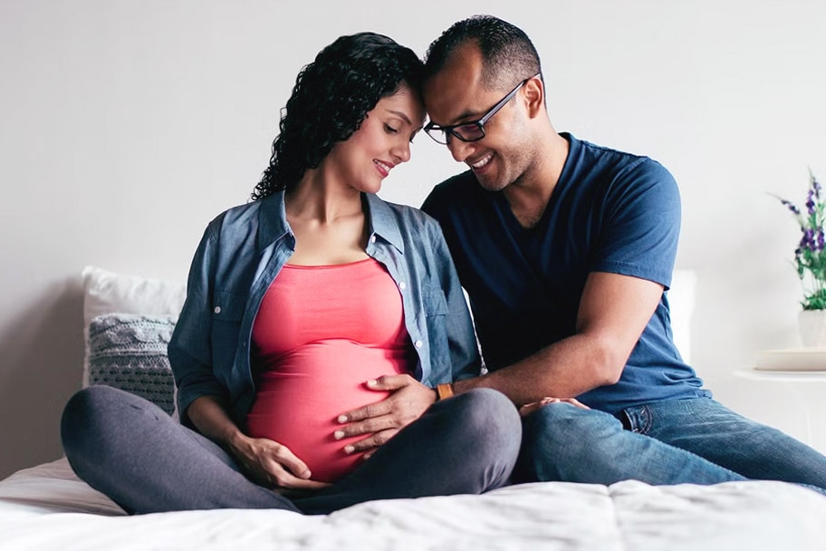 Partner touching pregnant person’s stomach