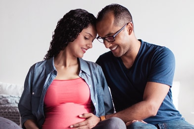 Person touching their pregnant partner’s stomach