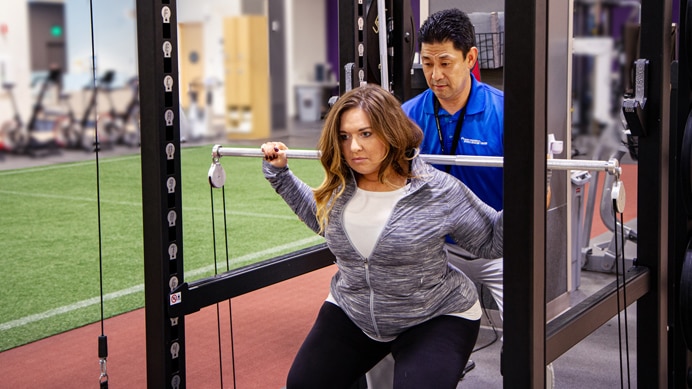 Person working with a trainer in a gym