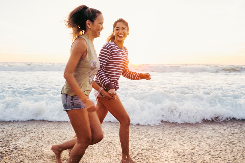 Two people jogging on the beach