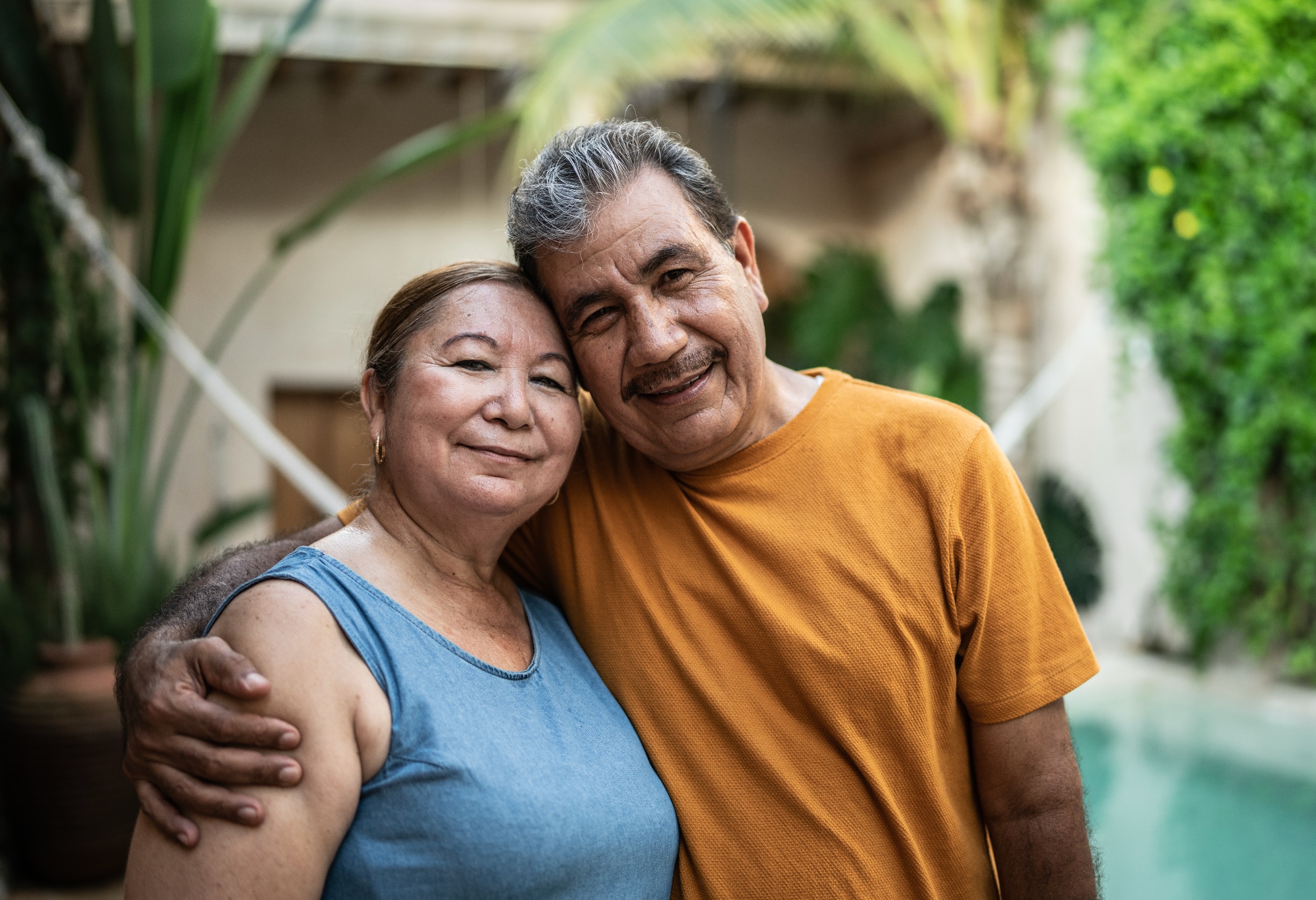 Two people standing close together outdoors