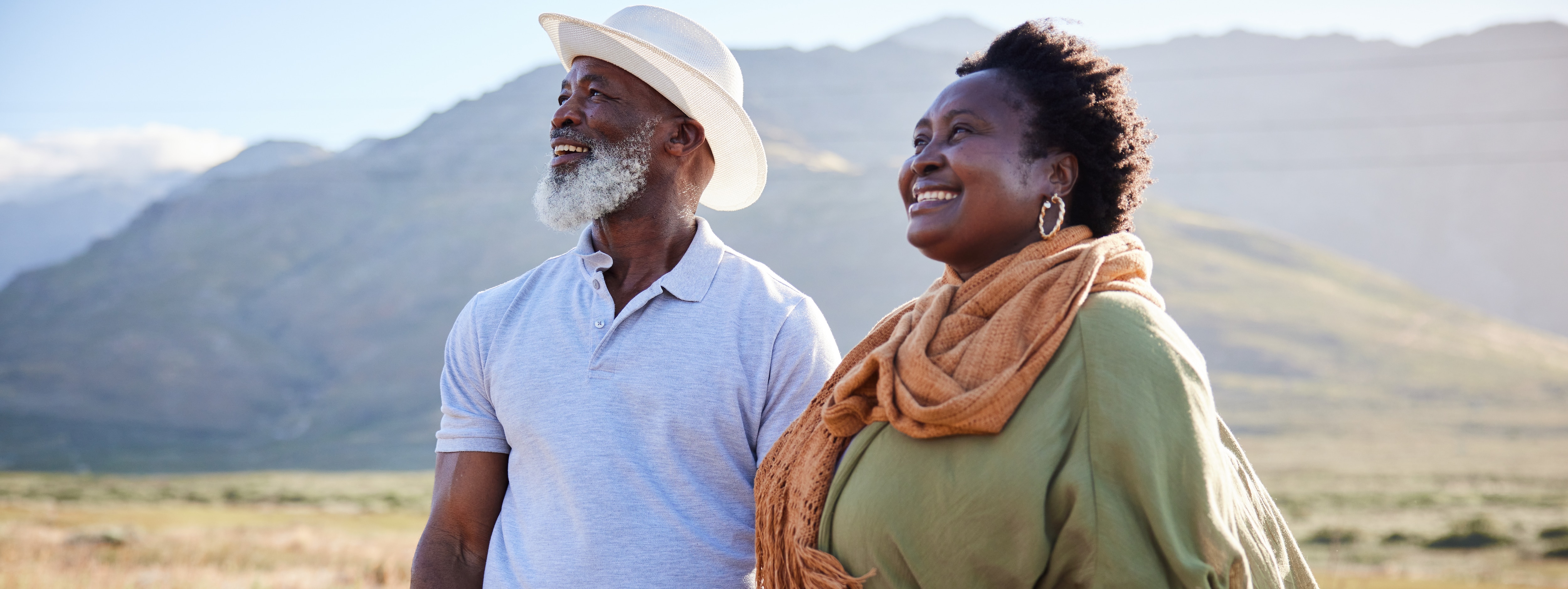 senior couple in the backyard with dogs smiling