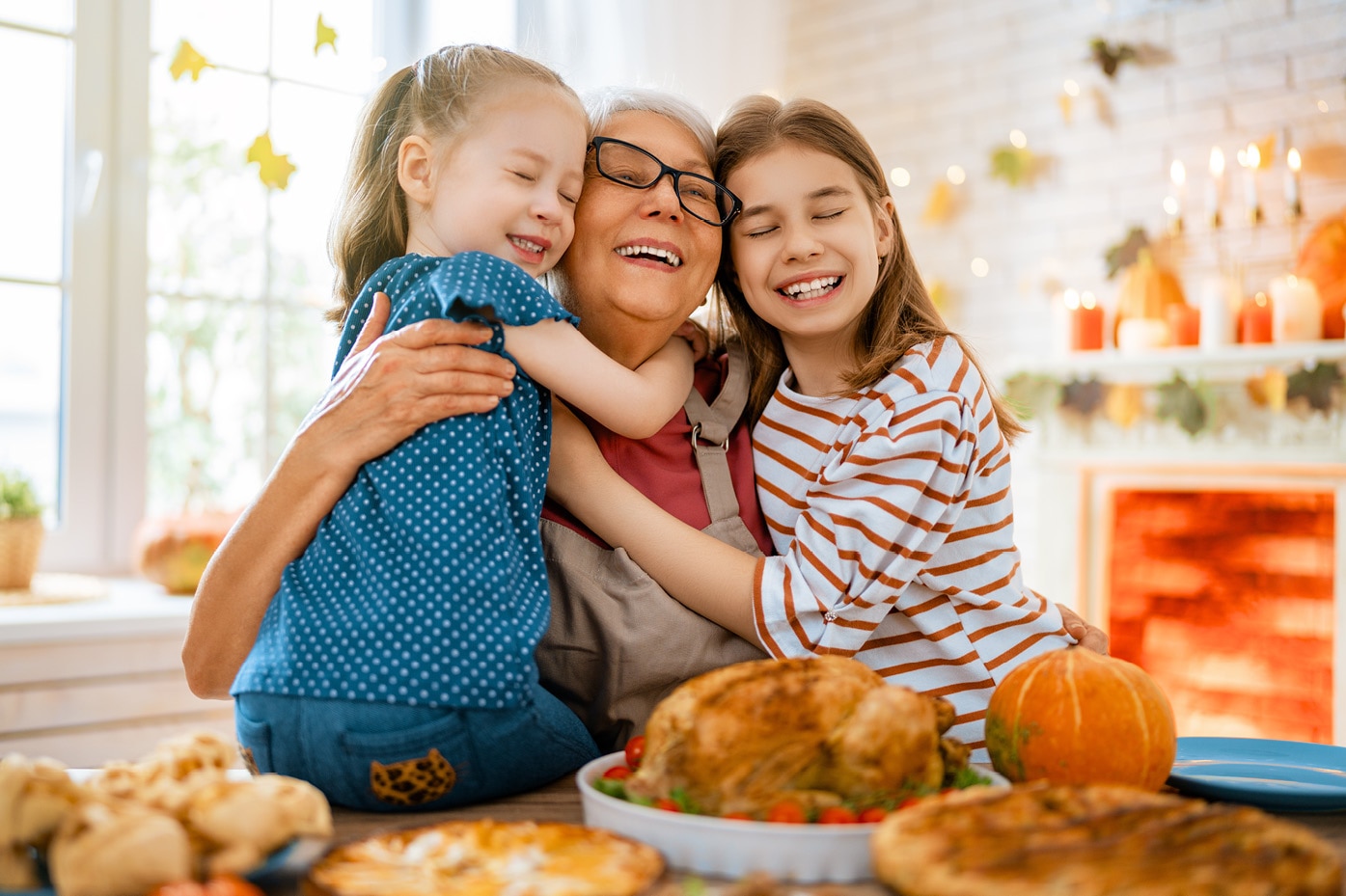 Children hugging adult at Thanksgiving