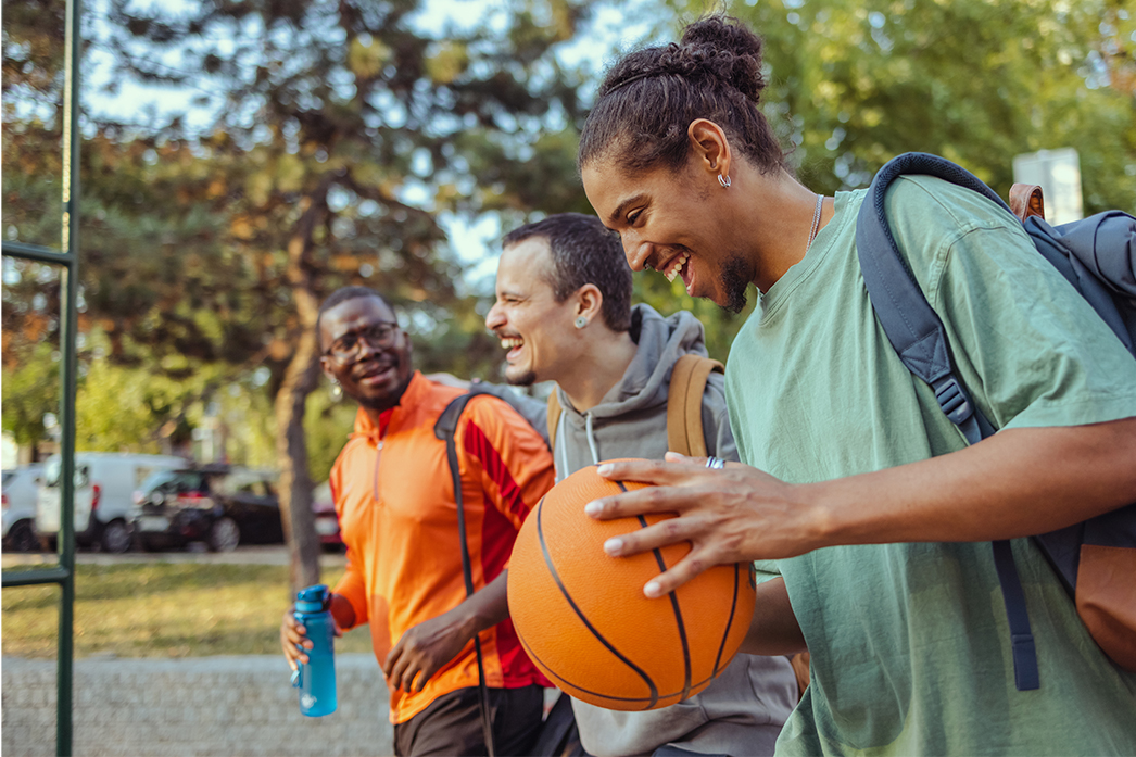 Friends walking to the park to play basketball