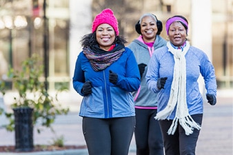 Group of friends jogging together, laughing