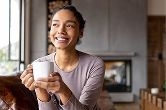 Person holding mug, smiling